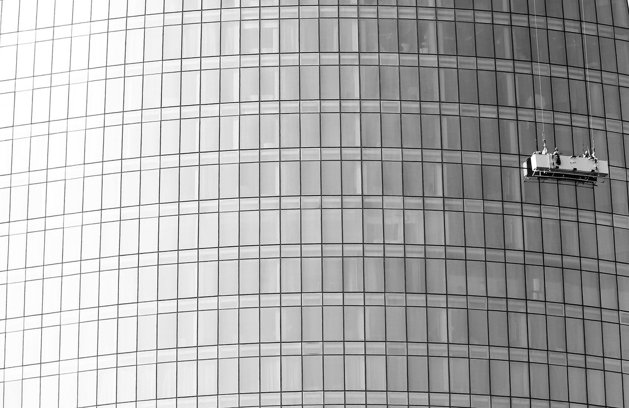 services-04 High-rise glass facade with suspended platform for window cleaning.