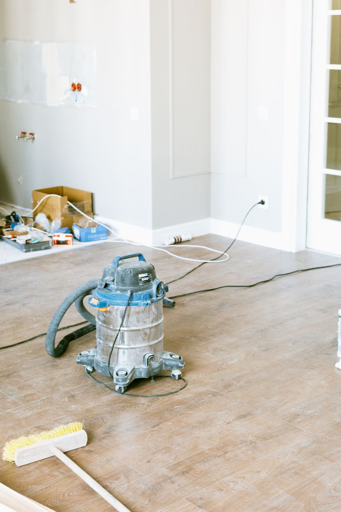 project-01-c Vacuum and tools in a room undergoing renovation, showcasing home improvement.